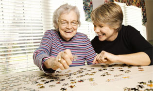 elderly woman and daughter doing a puzzle